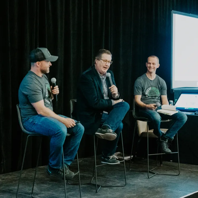 Three speakers answer questions during a Wealth Outside Wall Street panel.